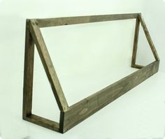 a wooden frame sitting on top of a white surface