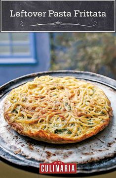 a pizza sitting on top of a metal pan covered in cheese and sauce next to a window