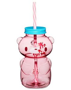 a pink bear shaped glass cup with a straw in it's mouth and a blue lid