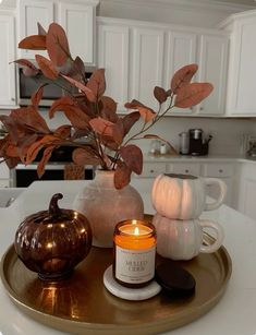 a candle is sitting on a tray in the kitchen