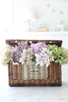 a basket filled with lots of flowers sitting on top of a table