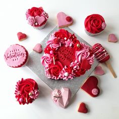 valentine's day cupcakes with pink frosting and red roses