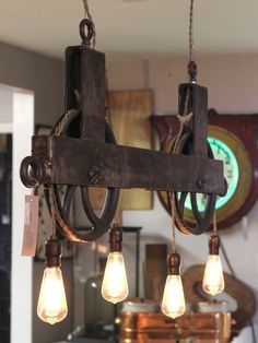 an old fashioned chandelier hanging from the ceiling in a room with other items