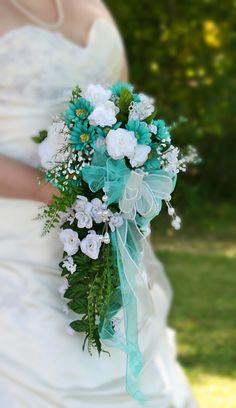 a bridal holding a bouquet of white and blue flowers