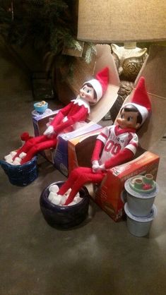 two elfs are sitting on top of boxes