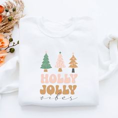 "Holly Jolly Vibes Christmas Sweatshirt, Christmas Shirt, Christmas TShirt, Cute Christmas, Christmas Gift, Holiday Sweater, Merry Christmas  HOW TO PLACE AN ORDER  Step 1: Select your preferred product color from the drop-down options  Step 2: Choose the correct size for your product. Step 3: Click add to cart  Step 4: Click \"Proceed to check out\"   ABOUT  ➤ Unisex ➤ Medium-heavy fabric (8.0 oz/yd² (271.25 g/m ➤ Loose fit ➤ Runs true to size ➤ 50% cotton, 50% polyester ➤ Sewn-in label ➤ No it Ugly Sweater Contest Winner, Holly Jolly Vibes, Family Christmas Sweaters, Ugly Sweater Contest, Cute Christmas Sweater, Christmas Sweater Party, Holiday Attire, Ugly Christmas Sweater Party, Christmas Tshirt