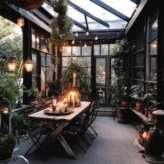 an indoor dining area with candles and potted plants