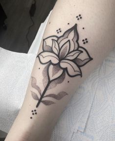 a black and white flower tattoo on the arm