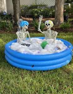 two skeletons playing in an inflatable pool