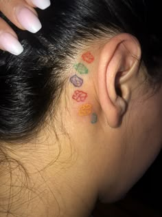 a woman's ear with colorful hearts on it