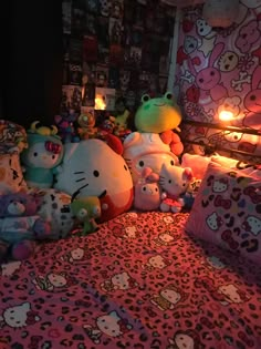 many hello kitty stuffed animals on a bed