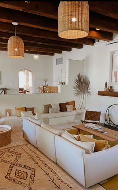 a living room filled with lots of white furniture