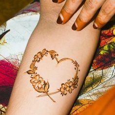 a woman's arm with a tattoo on it that has a heart in the middle