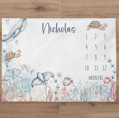 a placemat with an ocean theme and sea animals on it that says, nicholas