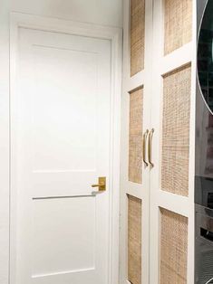 a white door with gold handles in a room