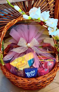 a basket filled with candy, candies and flowers