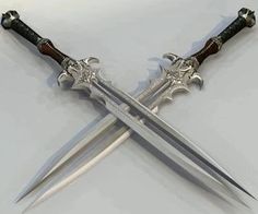 two swords are on display in front of a computer screen that displays the same image