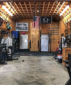 the inside of a gym with an american flag hanging from the ceiling and other equipment