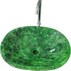 a green marble sink with chrome faucet