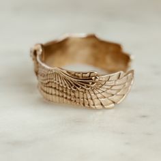 Buy in 14K Gold. A barred owl, carefully carved in tedious detail, one eye-straining feather at a time. A labor of love only made possible by profound meaning. Click [here] to discover the full story of how and why this piece came to be. The SMALL cuff fits up to a 6.75" wrist.The MEDIUM cuff fits up to a 7.5" wrist. MIMOSA bracelets are slightly adjustable. The first time you put your new bracelet on, adjust it one time to a size that slips on and off comfortably. Our jewelry is solid cast meta Bohemian Brass Bracelets With Etched Details, Adjustable Bohemian Brass Cuff Bracelet, Bohemian Gold Etched Cuff Bracelet, Bohemian Antique Gold Brass Cuff Bracelet, Texas Jewelry, Turquoise Eyes, Owl Bracelet, Owl Jewelry, Birthstone Bracelets