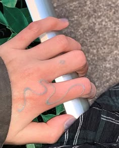 a person's hand with a small tattoo on it