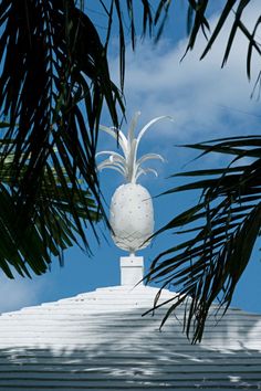 a white pineapple on top of a roof