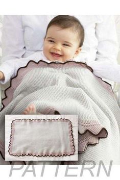 a baby is sitting in a crib with a blanket on it's lap