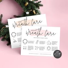 two white cards with black lettering on them next to a christmas tree and pink background