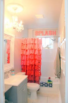 a bathroom with pink and orange shower curtains