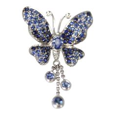 This is part of Chairish’s Fine Jewelry assortment.  Vintage circa 1960’s Sapphire butterfly brooch pendant 2 carats of sapphires  GORGEOUS BUTTERFLY BROOCH OR PENDANT CIRCA 1960 IS SET IN 18K WHITE GOLD. THIS GORGEOUS PIECE HAS A TASSEL OF SAPPHIRES DANGLING DOWN WITH MOVEMENT WHEN WALKING. THIS PIECE IS FRESH FROM AN AUCTION IN BERLIN AND IS IN EXCELLENT CONDITION. THERE ARE ABOUT 2 CARATS OF SAPPHIRES IN THIS BROOCH.  METAL: 18K WHITE GOLD WEIGHT: 6 GRAMS STONES: SAPPHIRES ROUND @ 2 CARATS SI Luxury Butterfly Brooch As Gift, Luxury Butterfly Brooches For Gifts, Blue Sapphire Brooch For Gift, Blue Sapphire Brooches For Gift, Blue Sapphire Brooches As Gift, Luxury Sapphire Brooches As Gifts, Luxury Sapphire Brooches For Gift, Elegant Sapphire Brooch For Gift, Luxury Sapphire Brooch Jewelry