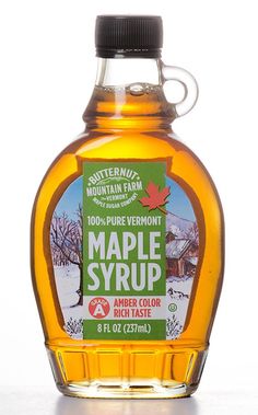 a bottle of maple syrup sitting on top of a table