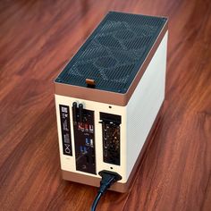 a small computer sitting on top of a wooden table