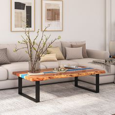 a living room with a couch, coffee table and pictures on the wall