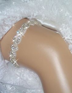 Garter, Weddings, Wedding Garter, Bridal Garter, Bridal, Rhinestone Garter, Crystal Garter, Garder, Wedding Garder,  Bling Garter Rhinestone trim bridal keepsake garter is encrusted with clear Czech crystals. in a unique and regal pattern. Rhinestone crystal and beaded trim is .75" wide and is a unique pattern of rhinestone twists and diamond shape. The crystals are accented with silver beads and the sparkling effect is breathtaking, especially when the light hits it The back is secured with a couple of inches of satin and cotton stretch elastic, so it should fit comfortably while staying in place on your special day. Please send me your thigh size approximately 6 inches above the knee. These are made to order The one pictured fits size 18 to 21 inches. This garter is also available as a s Silver Fitted Bridal Accessories, Elegant Bedazzled Bridal Belt For Wedding, Fitted Rhinestone Bridal Accessories For Party, Fitted Bridal Accessories With Rhinestones For Party, Elegant Rhinestone Bridal Accessories For Wedding, Crystal Bridal Accessories For Wedding, Elegant Fitted Bridal Accessories With Rhinestones, Glamorous Wedding Bridal Belt With Crystals, Glamorous Embellished Bridal Belt For Wedding