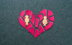 two pieces of paper cut out into the shape of a heart with people on it