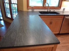 a counter top in a kitchen next to a sink