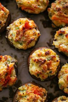 several mini pizzas with cheese and meat in them sitting on a plate next to some leaves