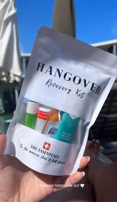 someone holding up a hangover recovery kit in their hand