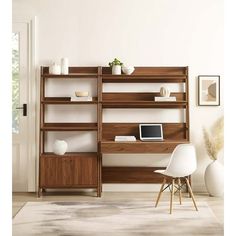 a desk with a laptop and chair in front of a book shelf filled with books