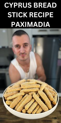 a man sitting in front of a bowl filled with corn