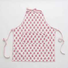 a pink and white apron with flowers on it