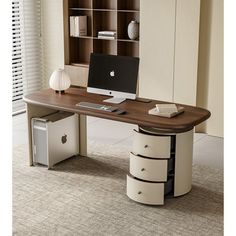 a desk with a computer on it in front of a bookcase and bookshelf