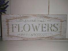 a wooden sign that says flowers seeds and bouquets