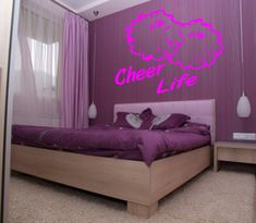 a bed room with a neatly made bed and purple walls