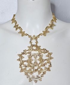 "Gorgeous 1970s Monet \"Primavera\" necklace. Gold toned filagree lace statement necklace. In excellent condition! Center piece is 5\" x 3.75\". Necklace measures 20\" long (including the 6\" extender). Monet hangtag is missing, but this is a confirmed Monet book piece. A true vintage showstopper!  *Please double check all pictures and description as there are no refunds or exchanges." Ornate Party Jewelry With Intricate Design, Filigree Pendant Jewelry For Party, Vintage Necklaces With Intricate Design For Evening, Ornate Choker Necklace With Intricate Design, Gold Bohemian Necklace For Evening, Elegant Festival Filigree Necklaces, Elegant Filigree Necklaces For Festivals, Vintage Gold Choker For Festivals, Ornate Filigree Necklaces For Evening