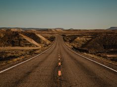 an empty road in the middle of nowhere with no cars or people driving on it