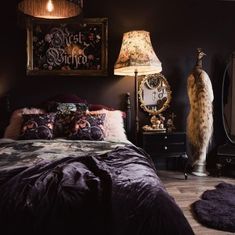 a bedroom with black walls and purple bedding