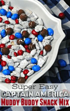 a white bowl filled with red, white and blue candy rocks on top of a checkered table cloth