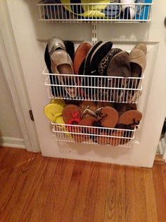 an image of a closet with shoes and other items in it on the bottom shelf