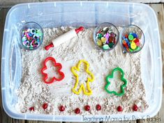 a plastic container filled with sand and toys